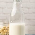 Cashew milk in a glass milk bottle.