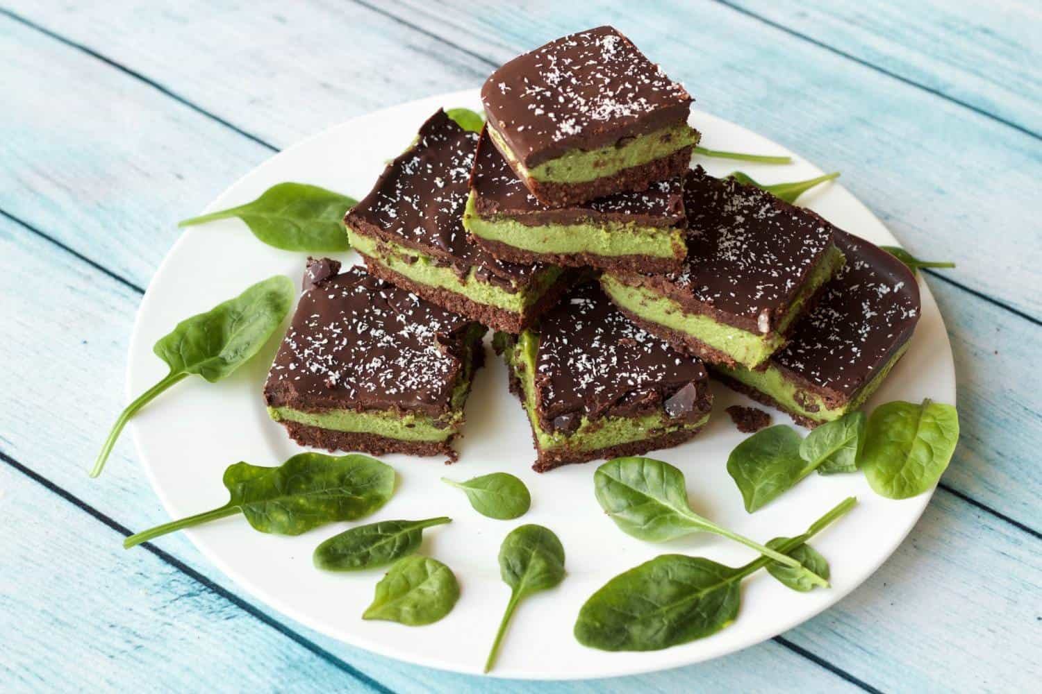 Raw mint slices stacked up on a white plate. 