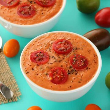 Raw tomato soup in white bowls.