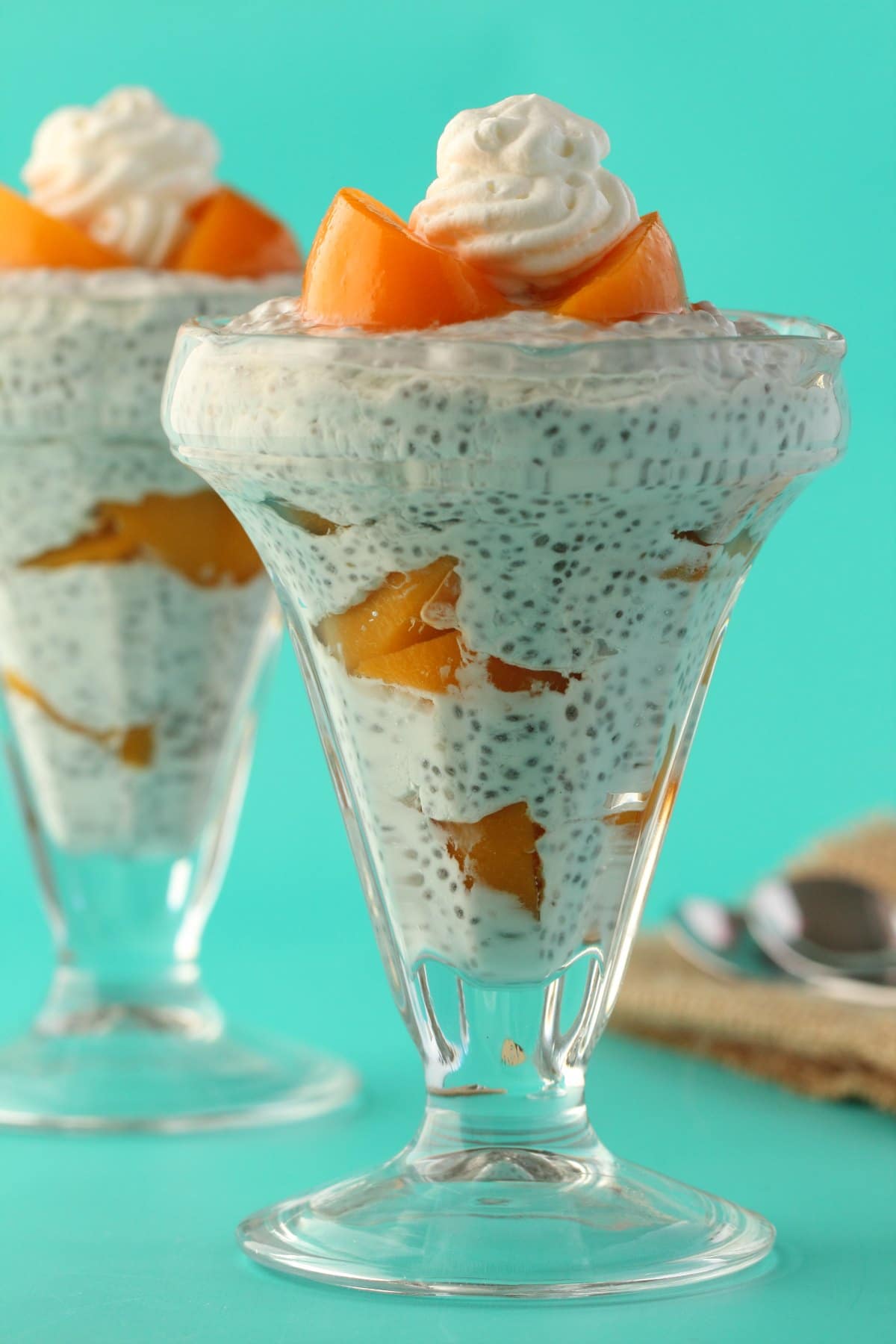 Chia pudding in sundae glasses with canned peaches. 