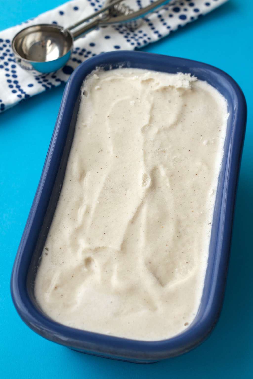 Vegan vanilla ice cream in a blue ceramic loaf pan. 