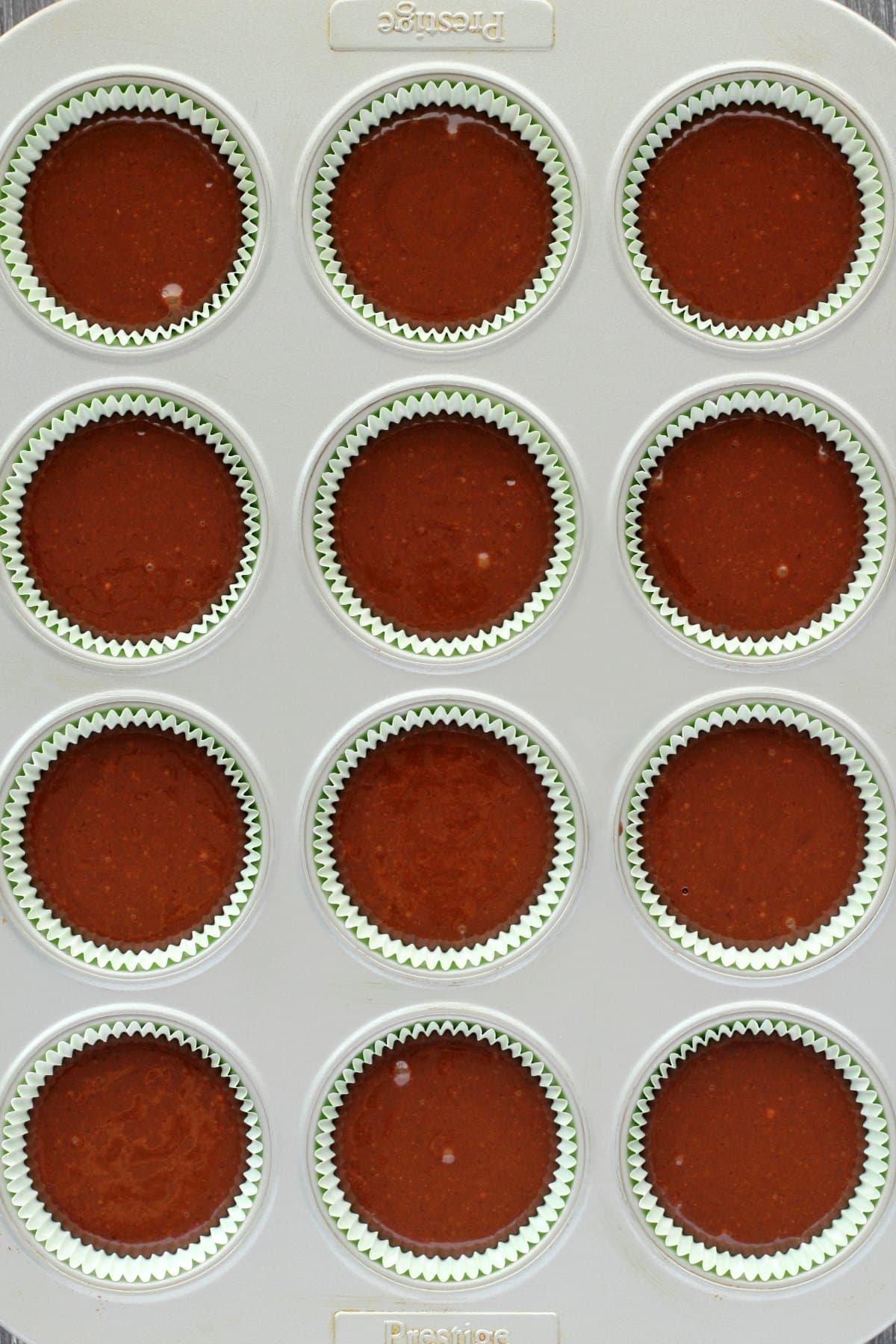 Batter for chocolate cupcakes in a cupcake tray ready to bake.