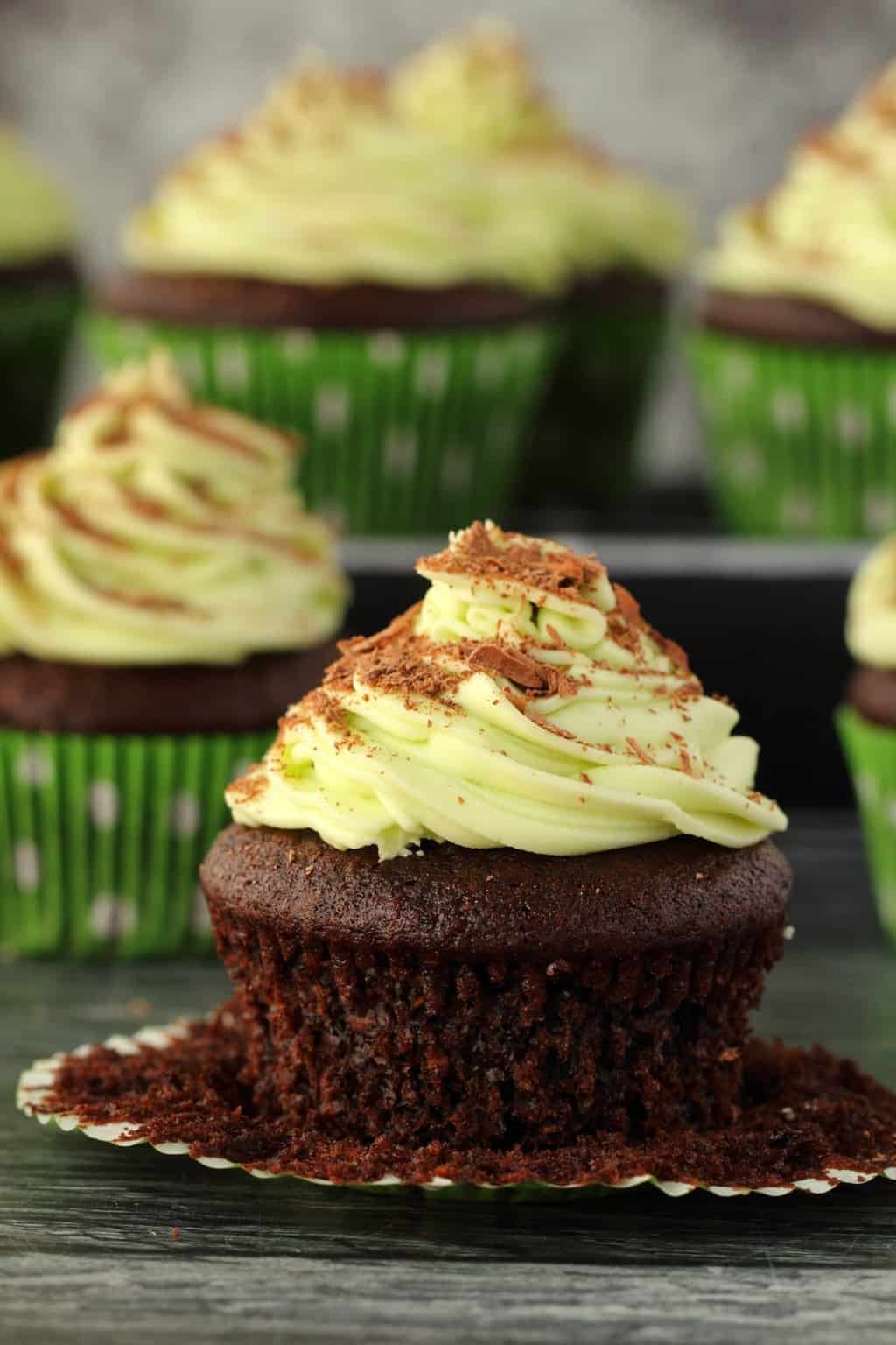 Vegan chocolate cupcakes topped with mint buttercream frosting and chocolate shavings.