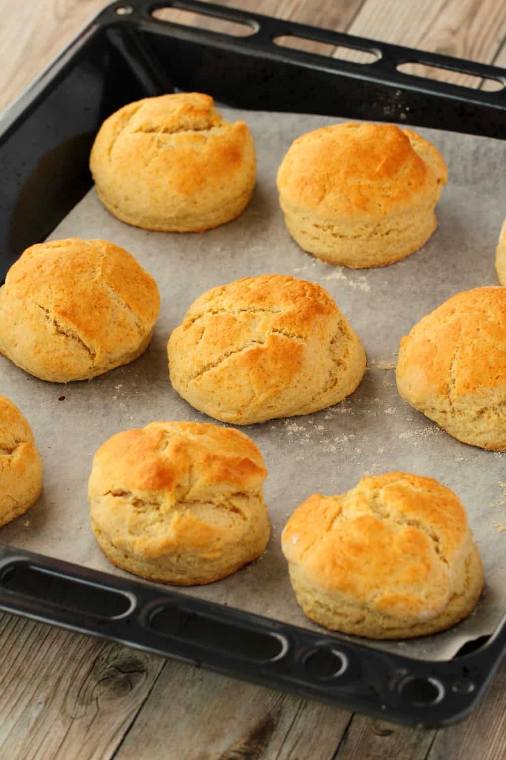 Freshly baked vegan scones on a parchment lined baking tray. 