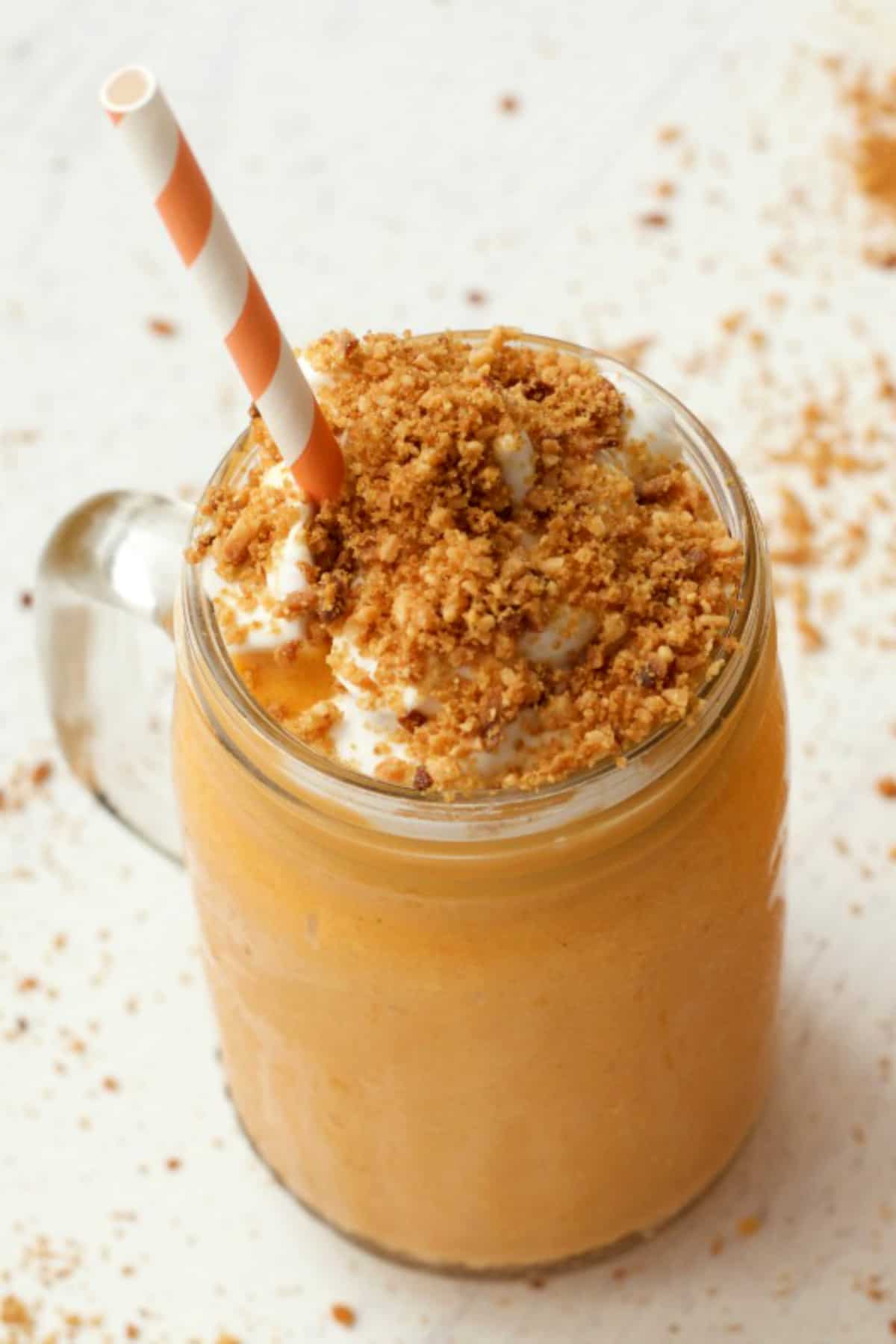 Smoothie in a glass with toasted coconut and whipped cream. 