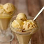 Salted caramel ice cream topped with salted caramel sauce in sundae glasses.