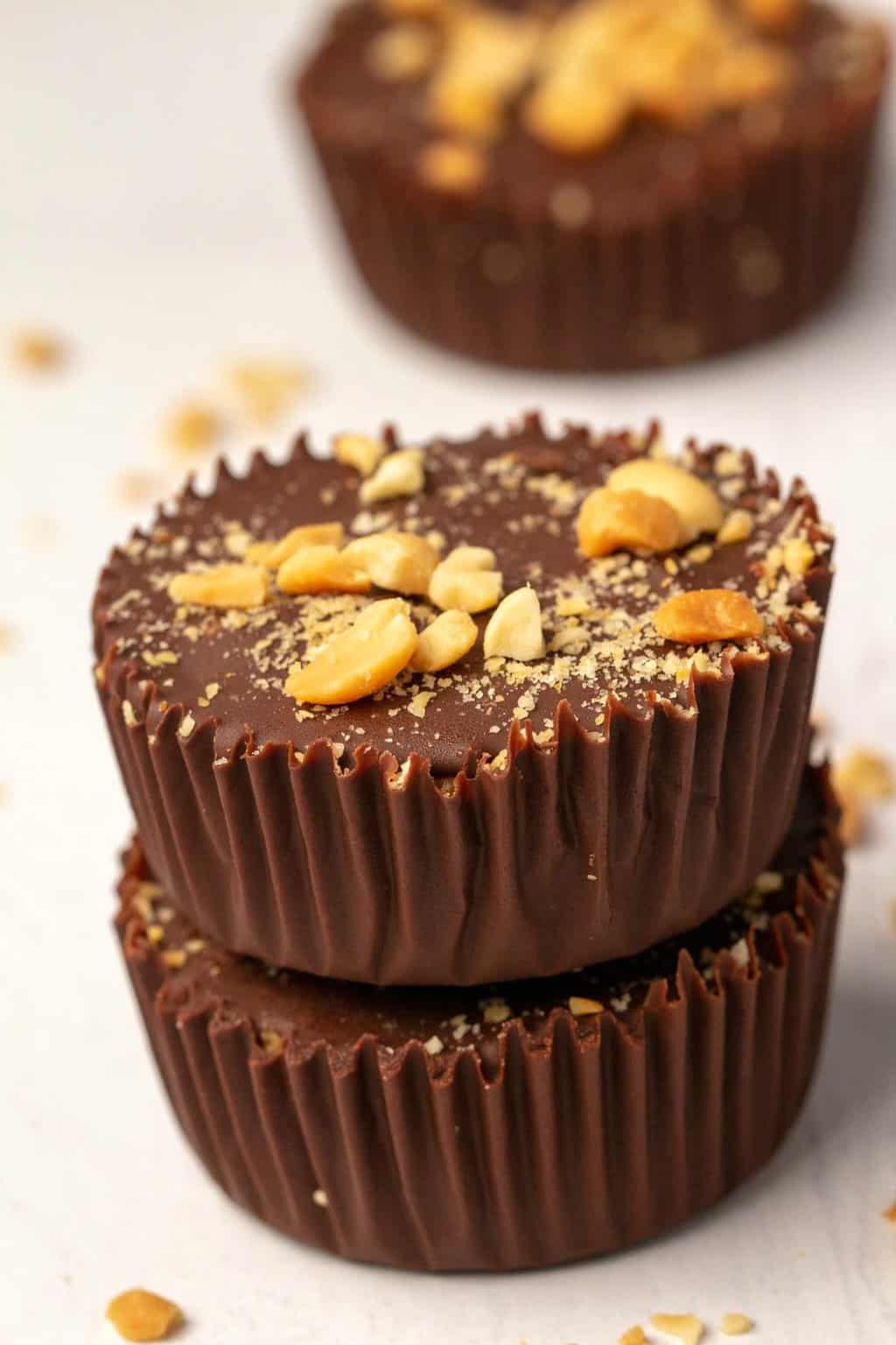 A stack of two peanut butter cups topped with crushed peanuts. 