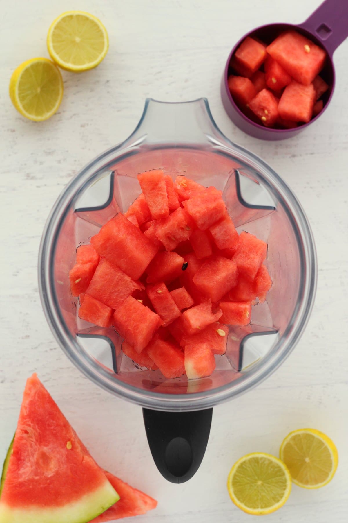 Cubed watermelon for a watermelon smoothie in a blender jug. 