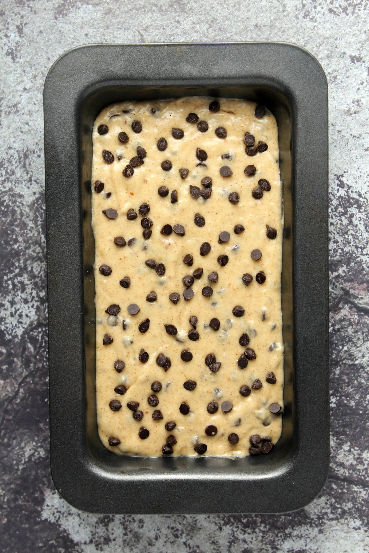 Vegan chocolate chip banana bread batter in a loaf pan ready to bake.