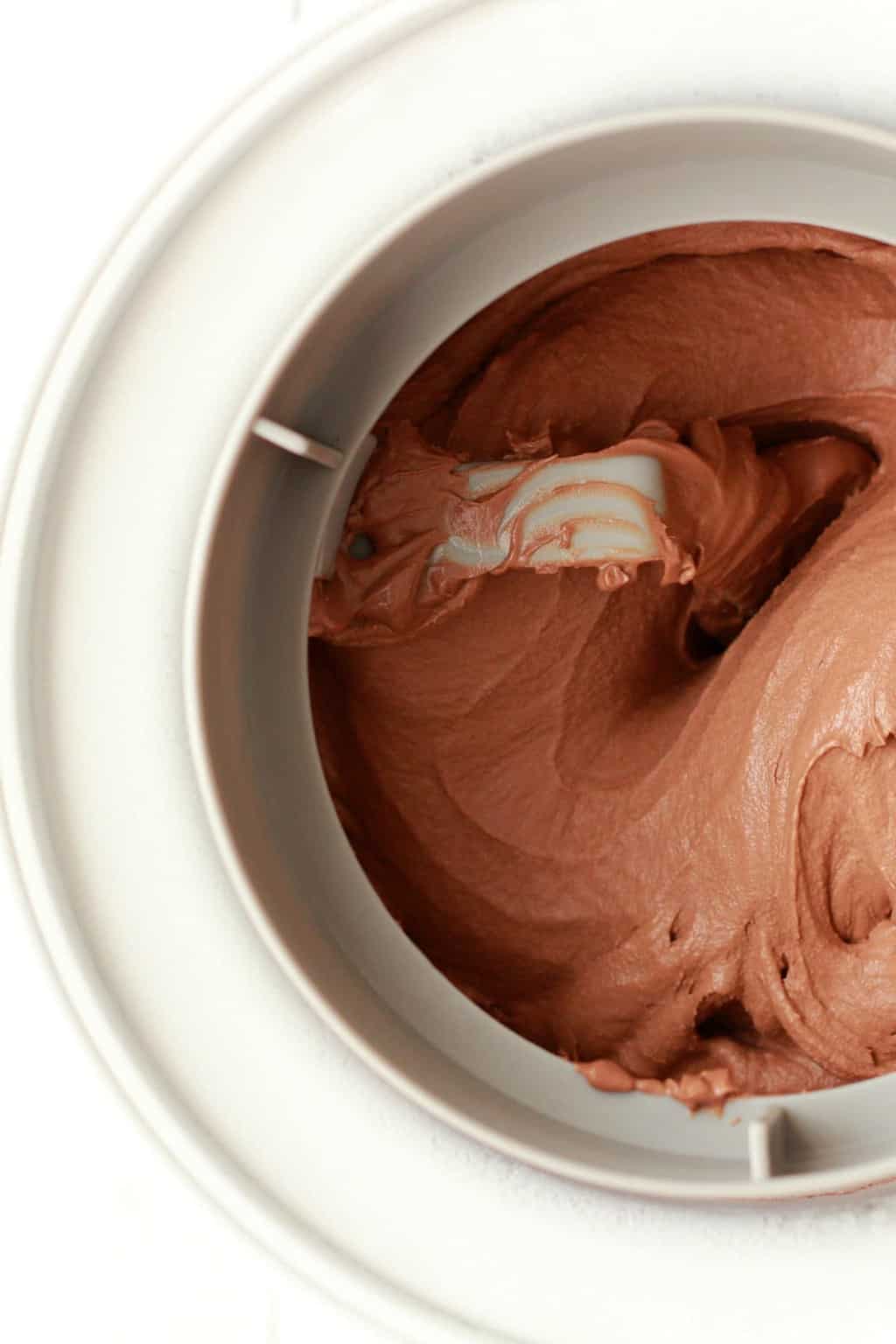 Vegan chocolate ice cream churning in an ice cream machine. 