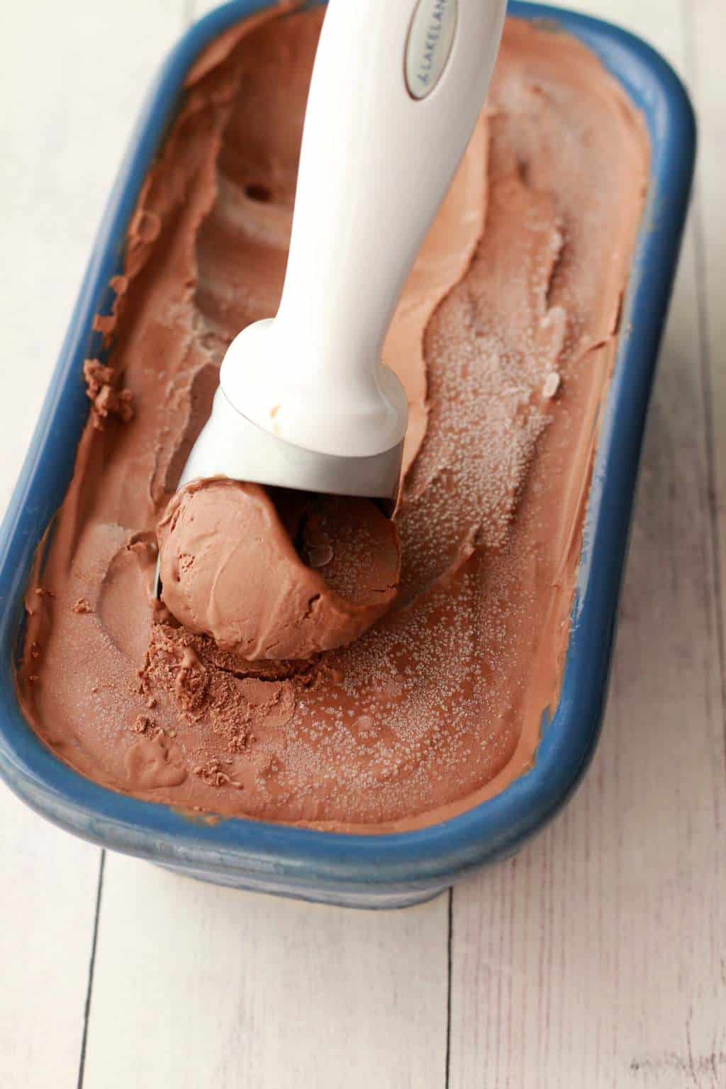 Scooping ice cream with an ice cream scoop. 