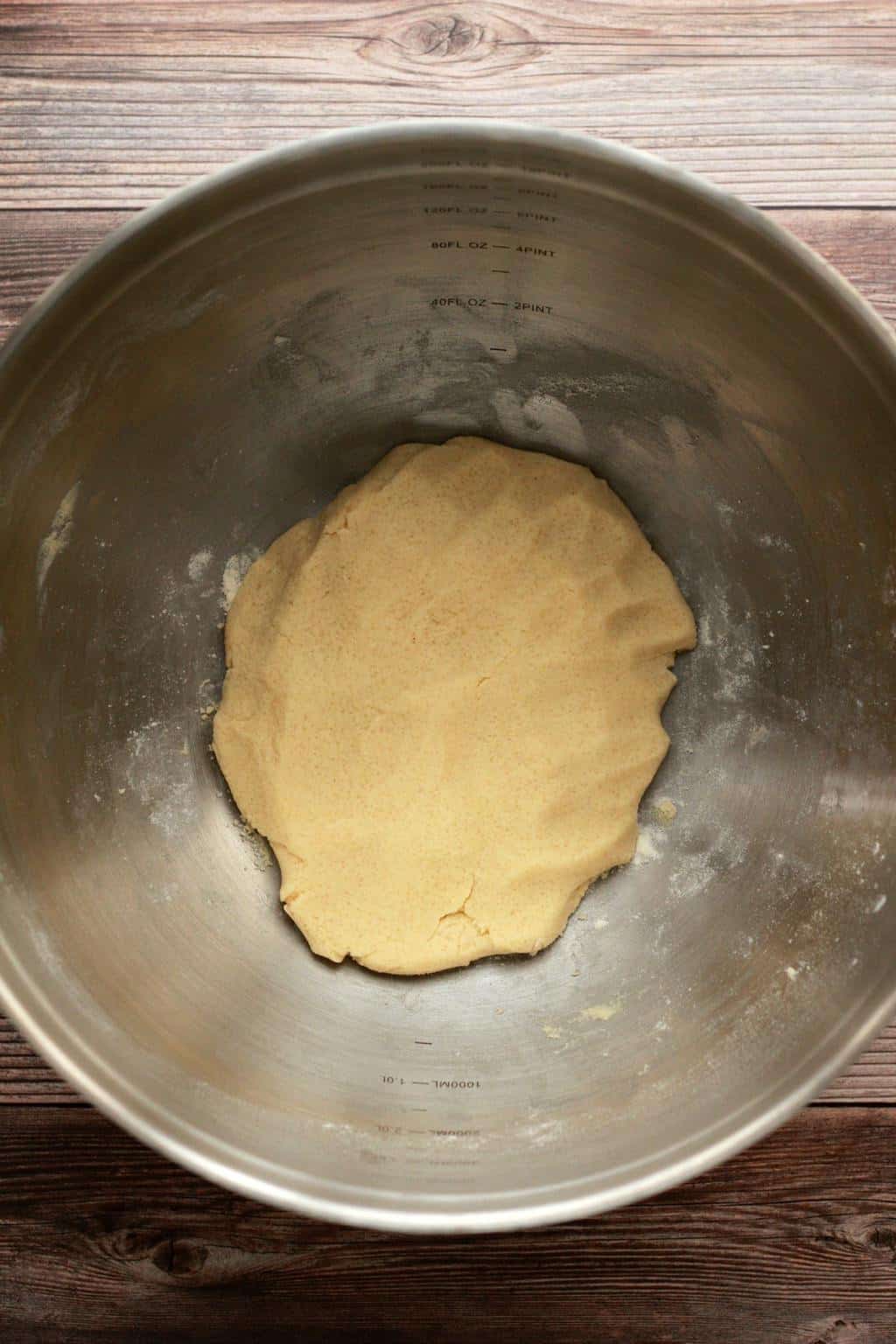 Cookie dough for shortbread cookies in a stainless steel mixing bowl. 