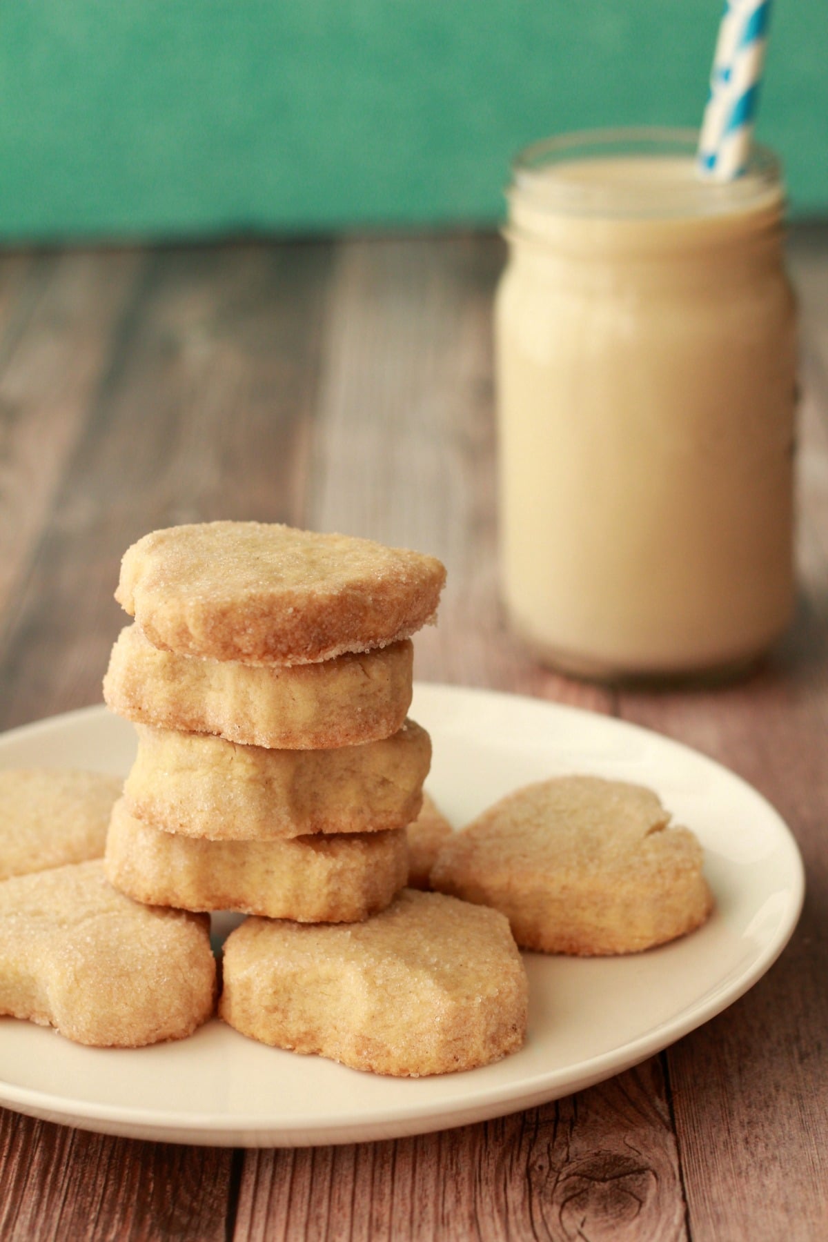 Vegan shortbread cookies stacked up on a white plate. 