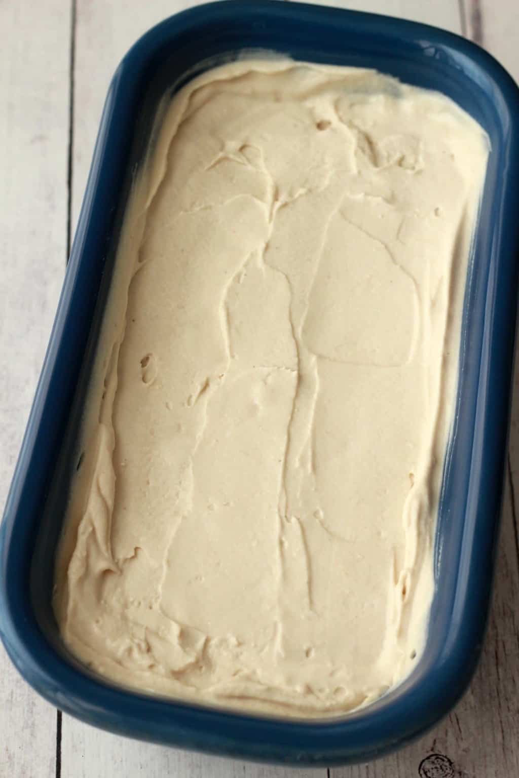 Vegan cheesecake ice cream in a blue loaf pan. 