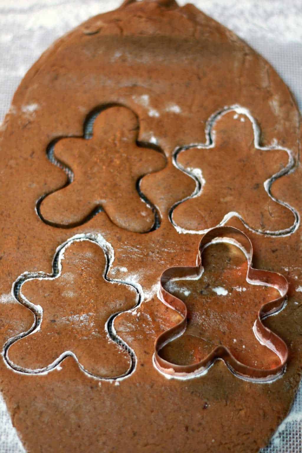Cutting out vegan gingerbread cookies from rolled out cookie dough. 