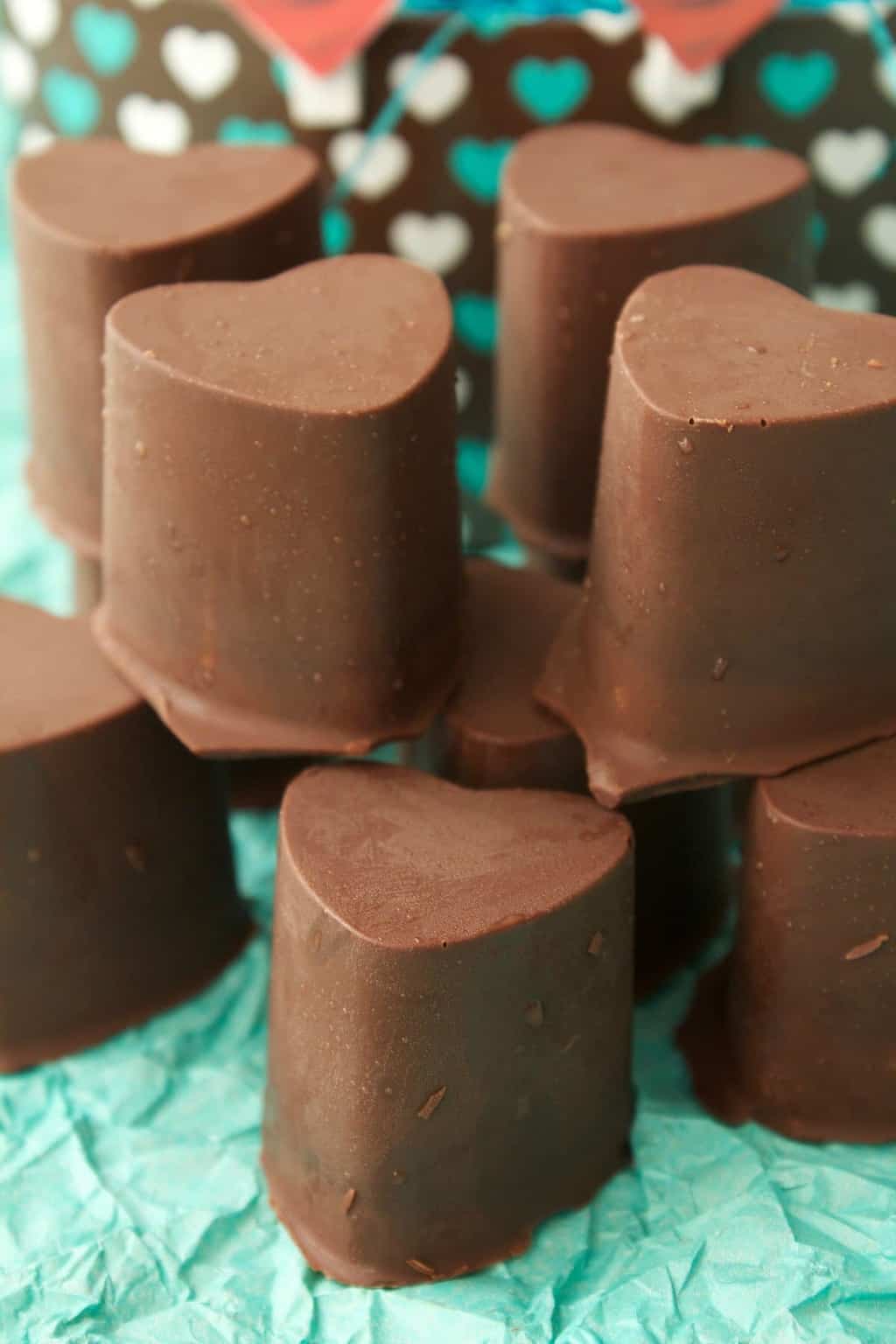 Heart-shaped vegan chocolate caramels in a stack.