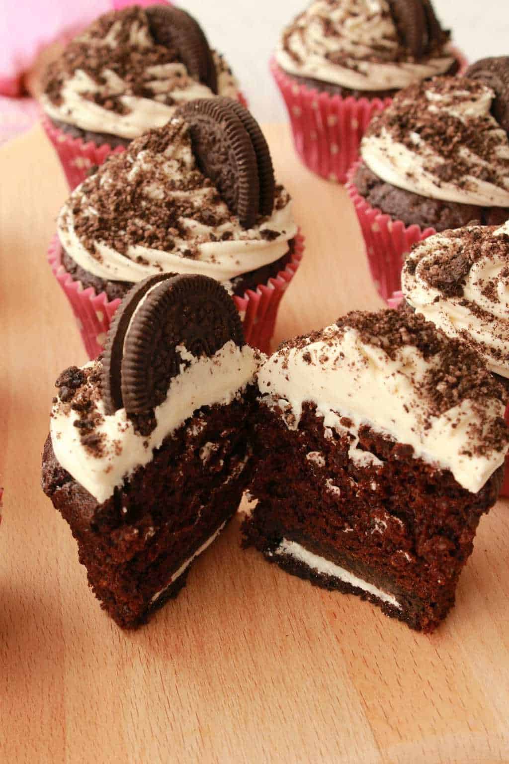 An oreo cupcake cut in half to show the center. 