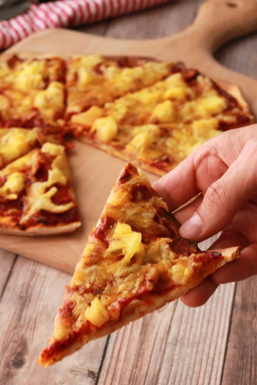Thin-Crust Vegan Pizza. Made from scratch with homemade vegan pizza dough, a homemade tomato sauce and Hawaiian toppings! #vegan #lovingitvegan #veganpizza #pizza