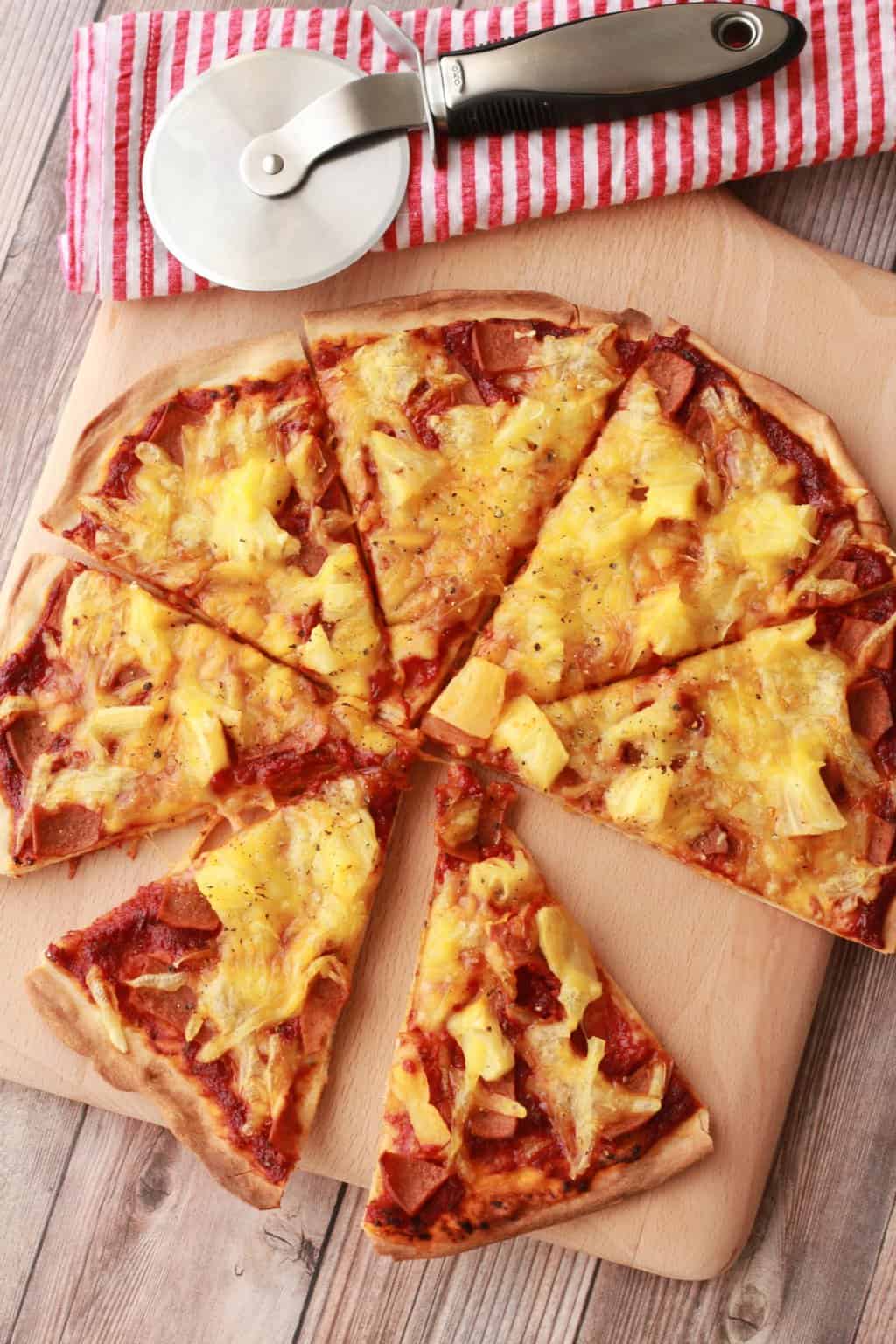 Thin-Crust Vegan Pizza. Made from scratch with homemade vegan pizza dough, a homemade tomato sauce and Hawaiian toppings! #vegan #lovingitvegan #veganpizza #pizza