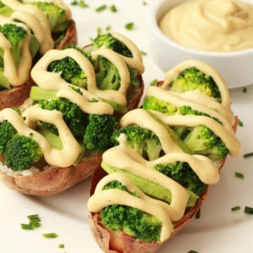 Cashew cheese sauce drizzled over baked potatoes and broccoli.