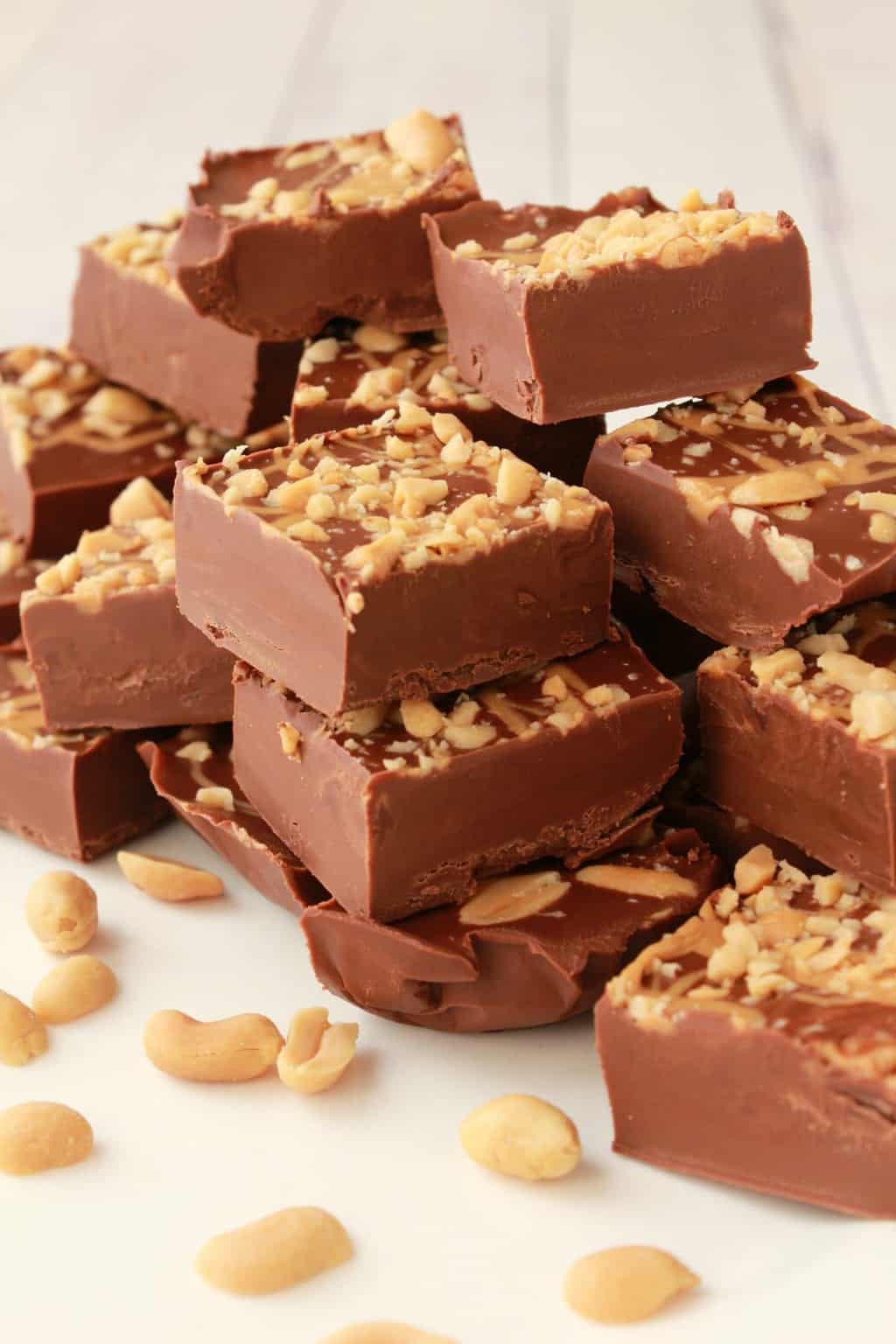 Vegan chocolate peanut butter fudge squares stacked up. 