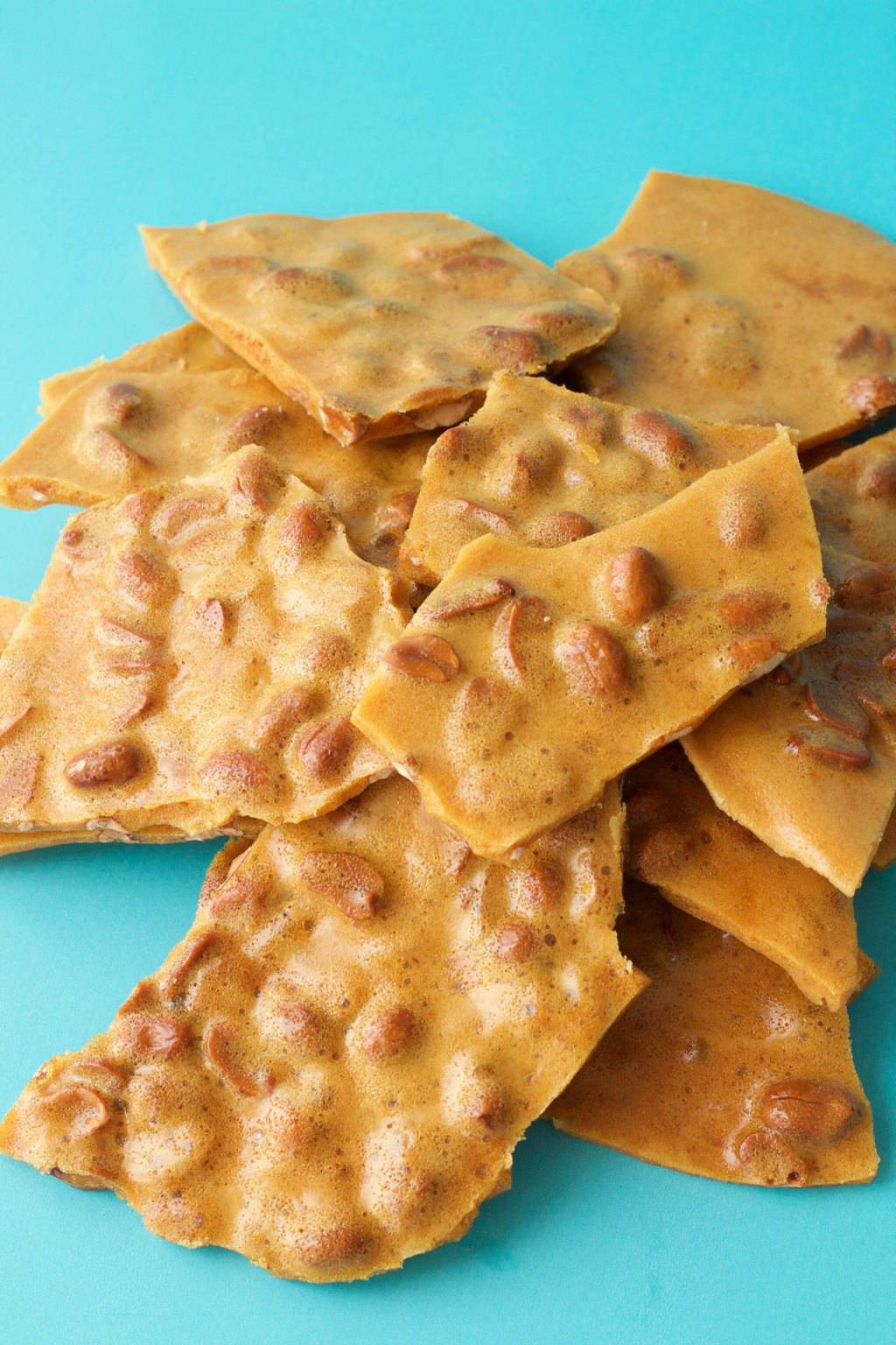 Vegan peanut brittle pieces stacked up. 