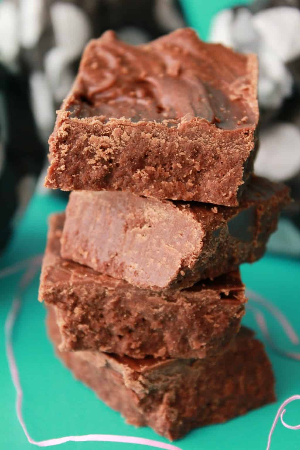 Vegan chocolate fudge squares in a stack. 