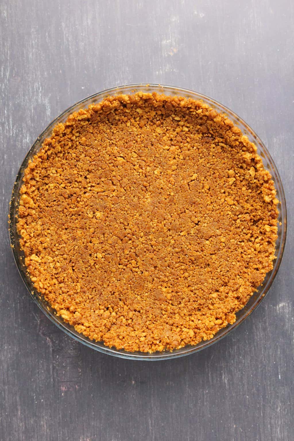 Crushed ginger cookie and vegan butter pie base for a vegan lemon pie. 