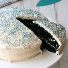 Vegan blue velvet cake on a white cake stand.