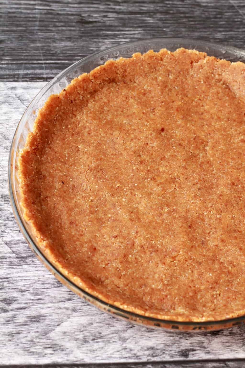 Walnut, date and coconut crust pressed into a glass pie dish. 