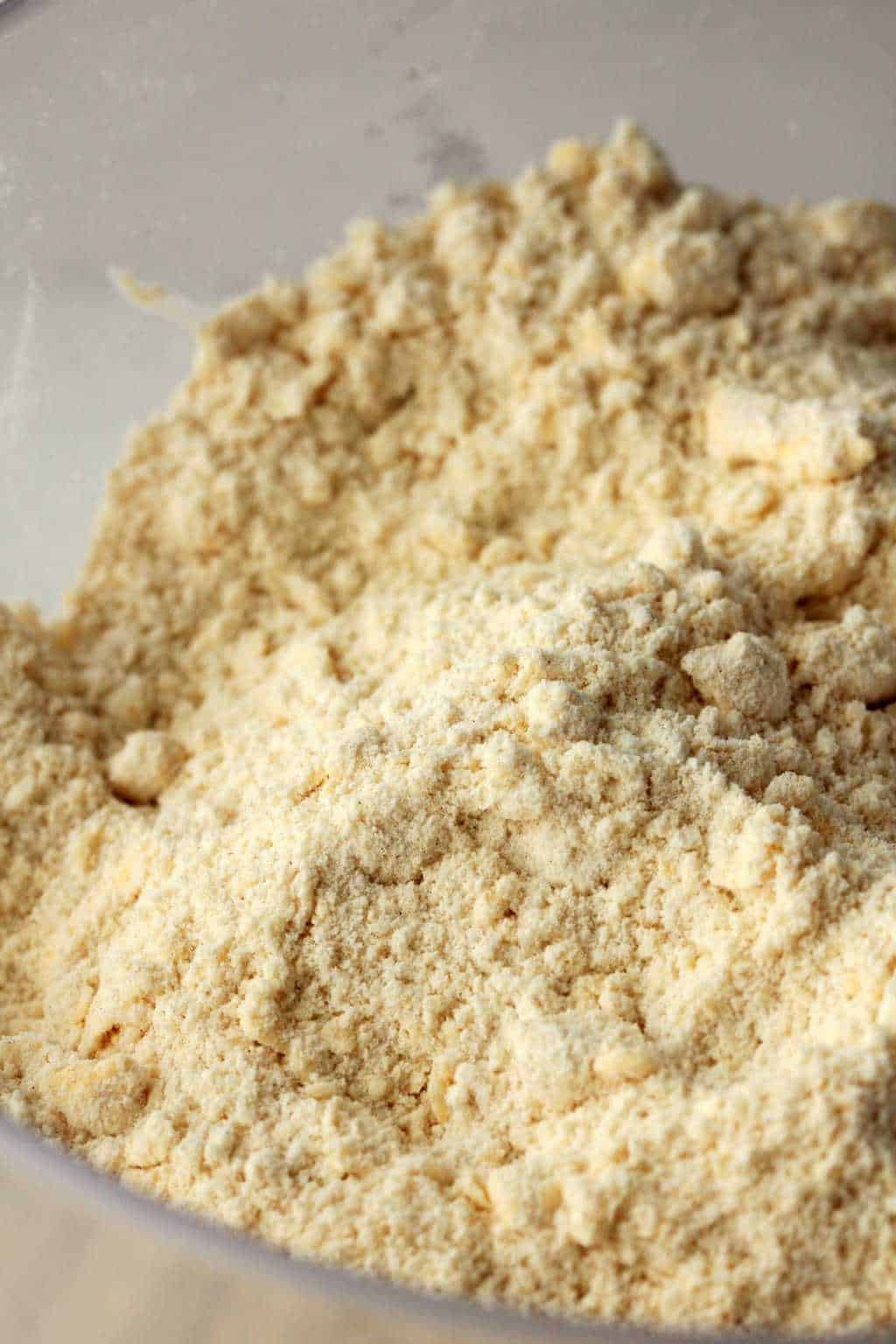 Flour, salt, baking powder, sugar and vegan butter crumbled together in a mixing bowl. 