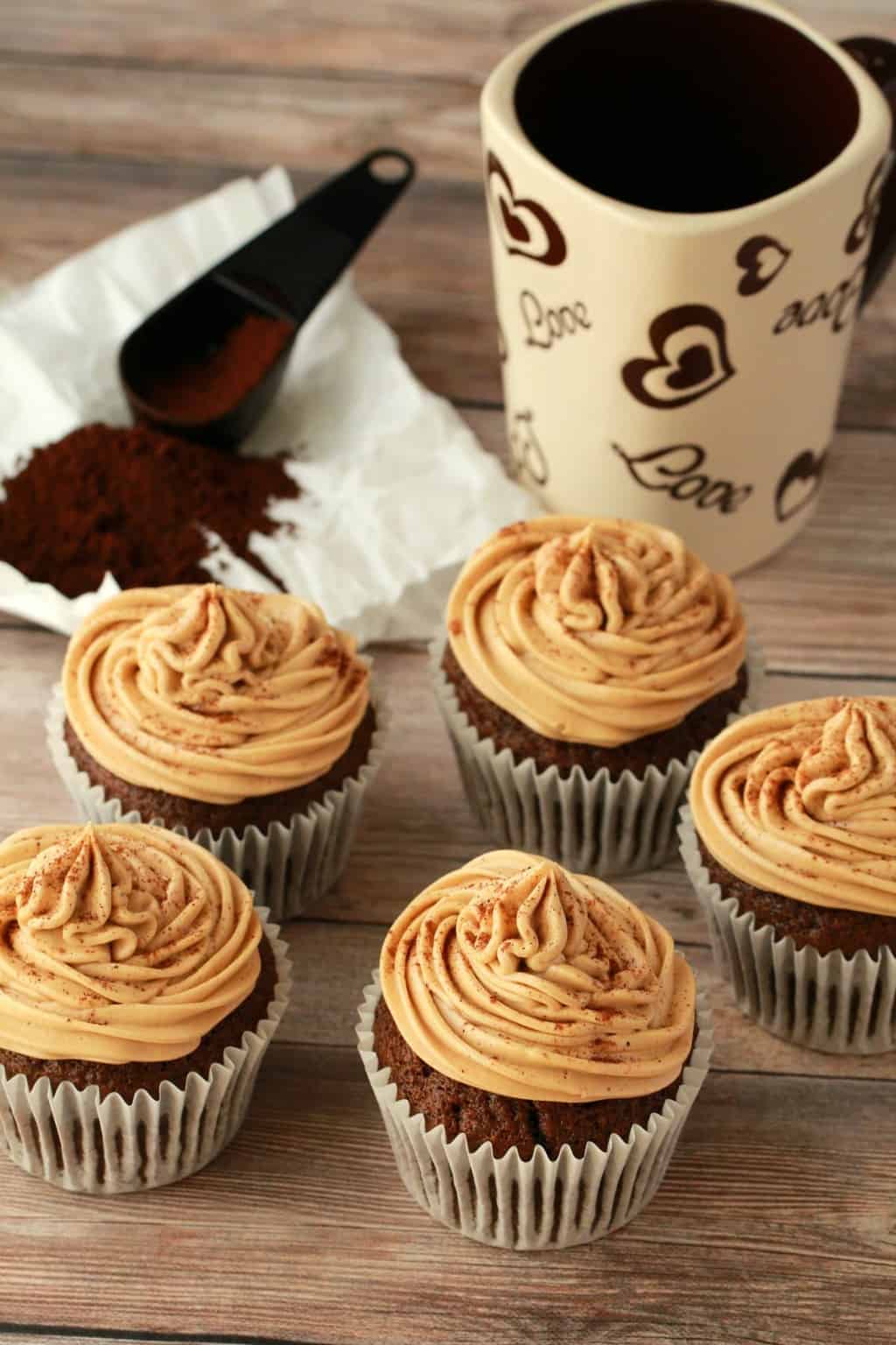 Coffee cupcakes topped with coffee buttercream frosting and a sprinkle of cinnamon. 