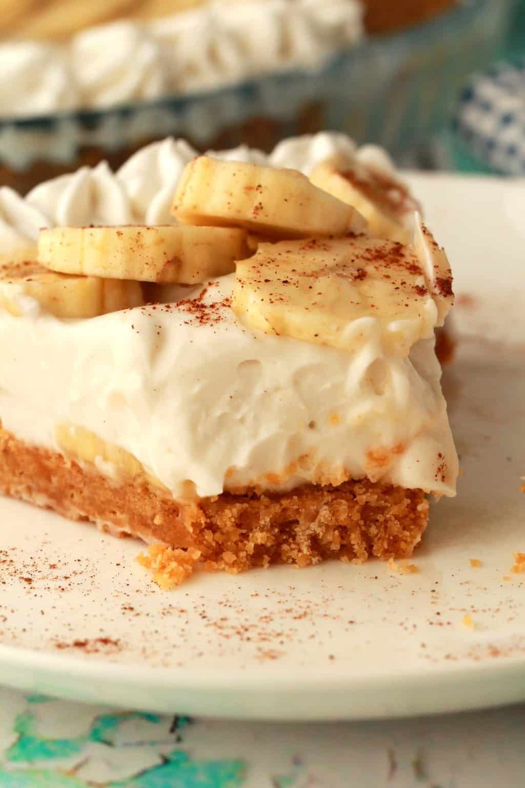 A slice of banana cream pie on a white plate. 