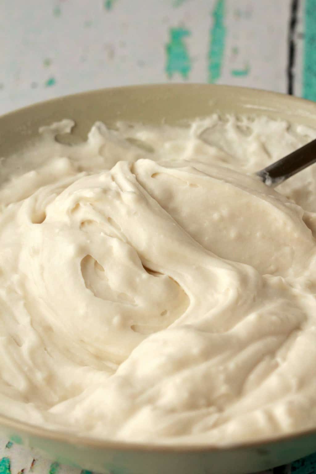 Stirring vegan whipped cream and vanilla pudding together. 