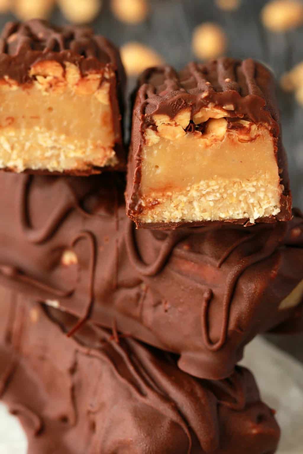 A stack of homemade snickers bars. 
