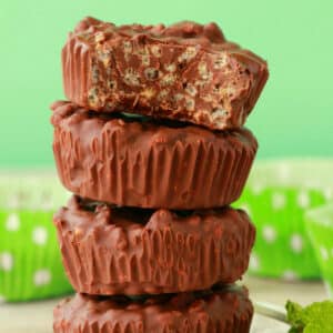 Chocolate mint crunch cups in a stack.