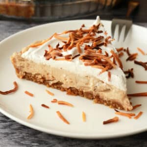 Slice of vegan coconut cream pie on a white plate.
