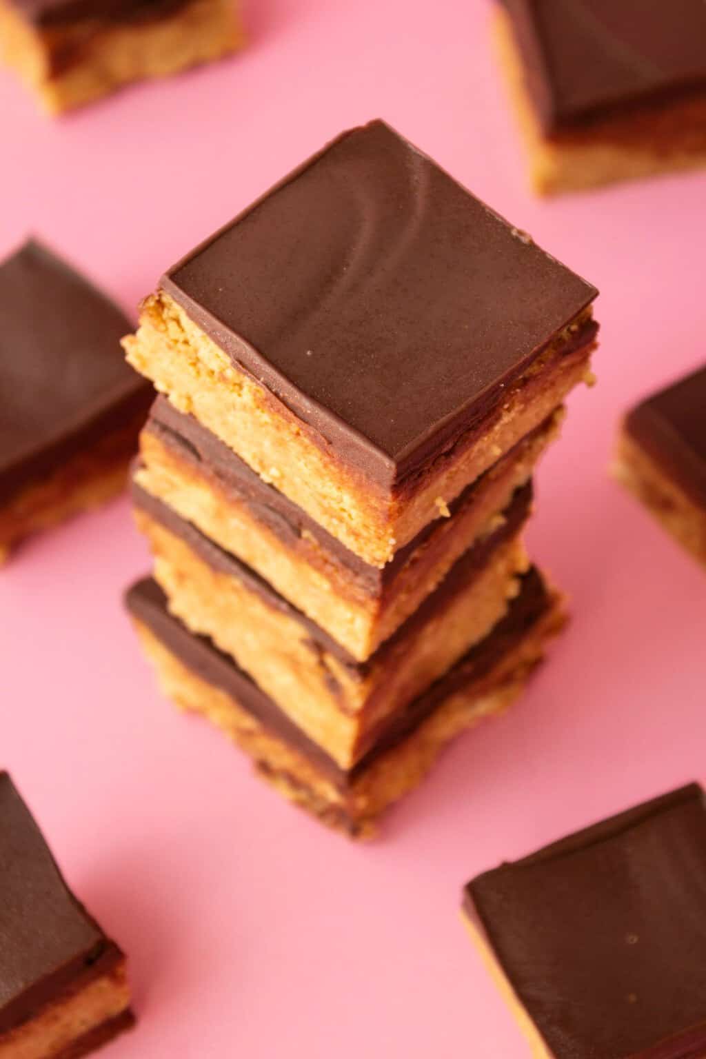 Vegan peanut butter bars stacked up on top of each other. 