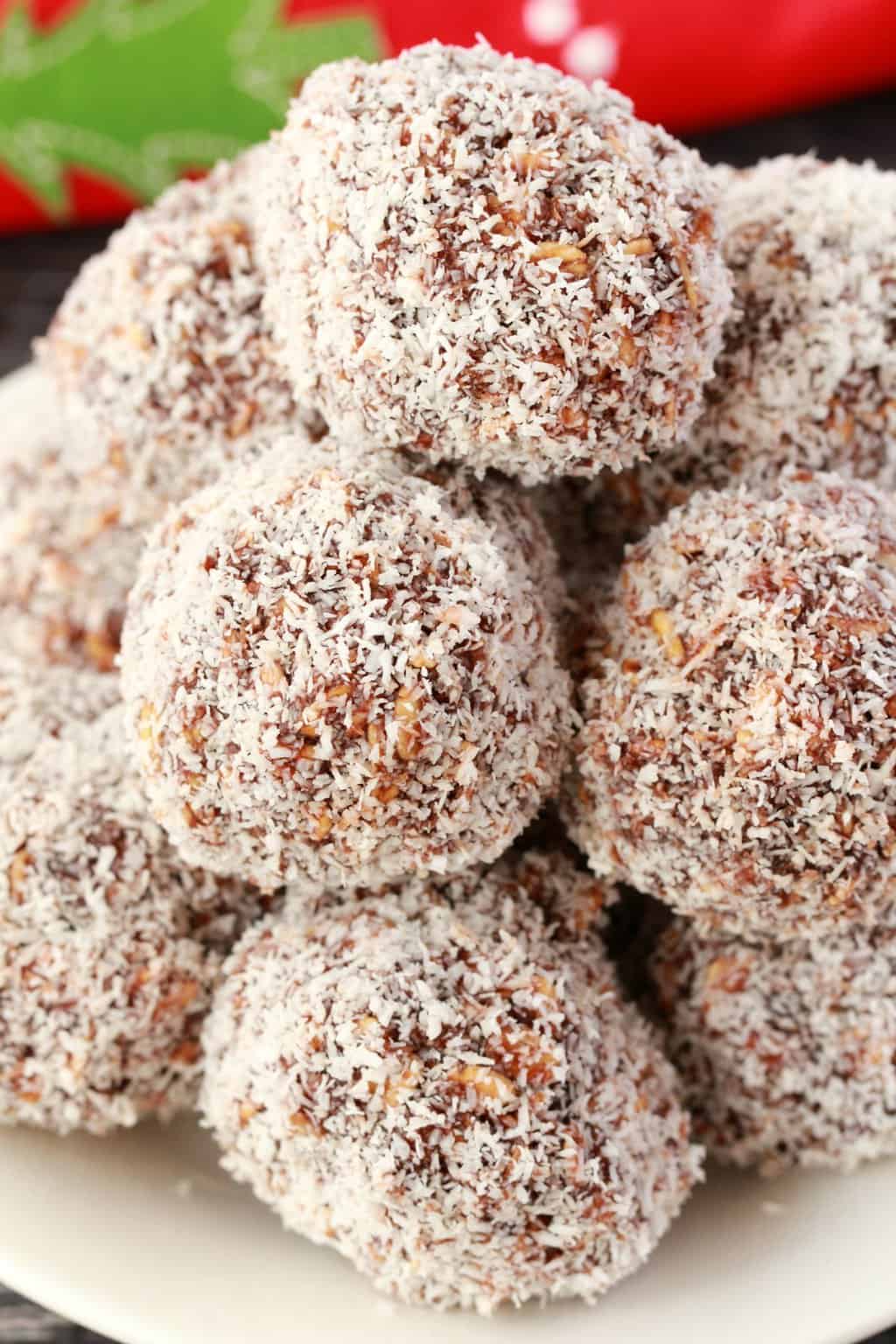 Chocolate snowballs stacked up on a white plate. 