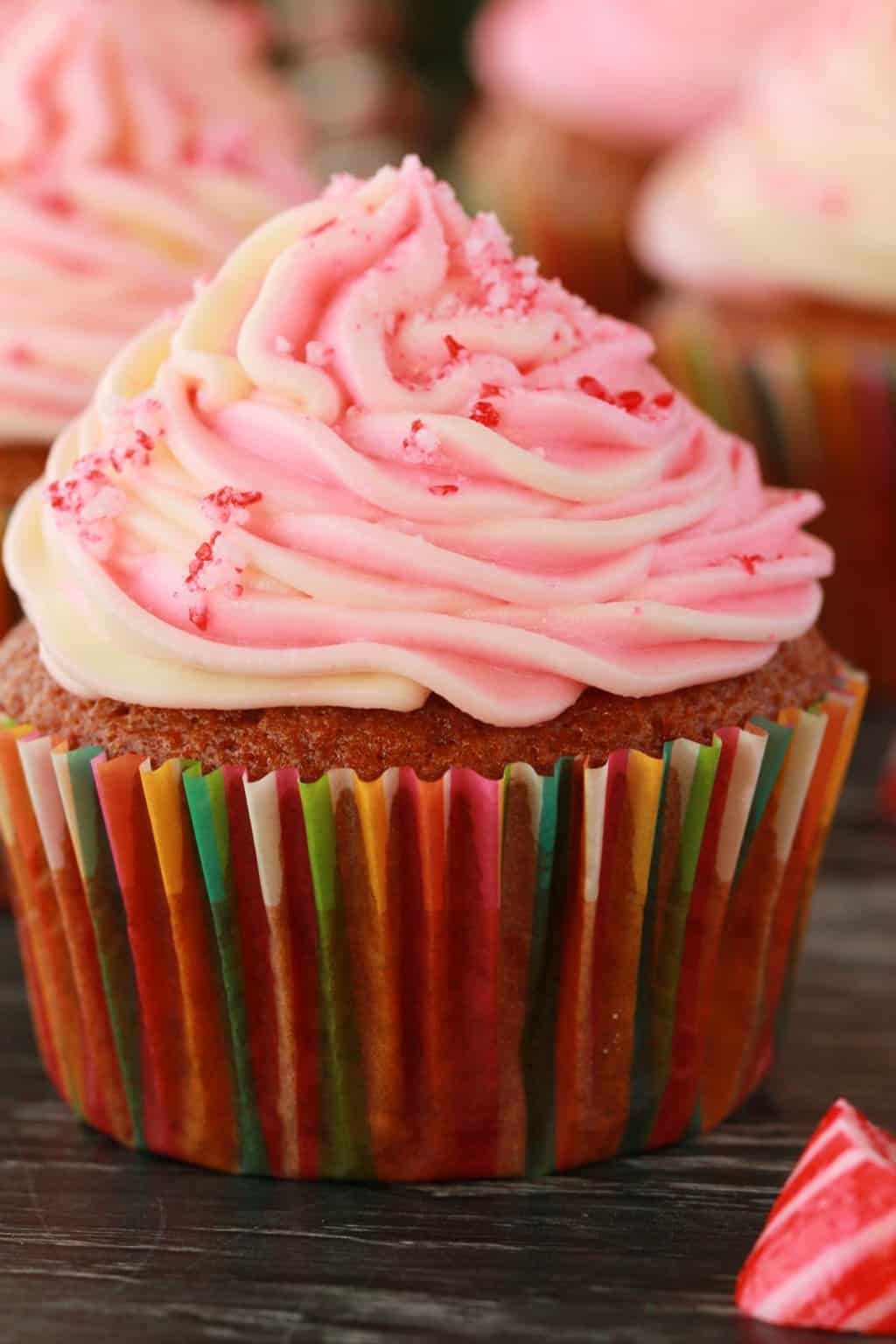 Vegan peppermint cupcakes topped with a pink and white swirled frosting. 