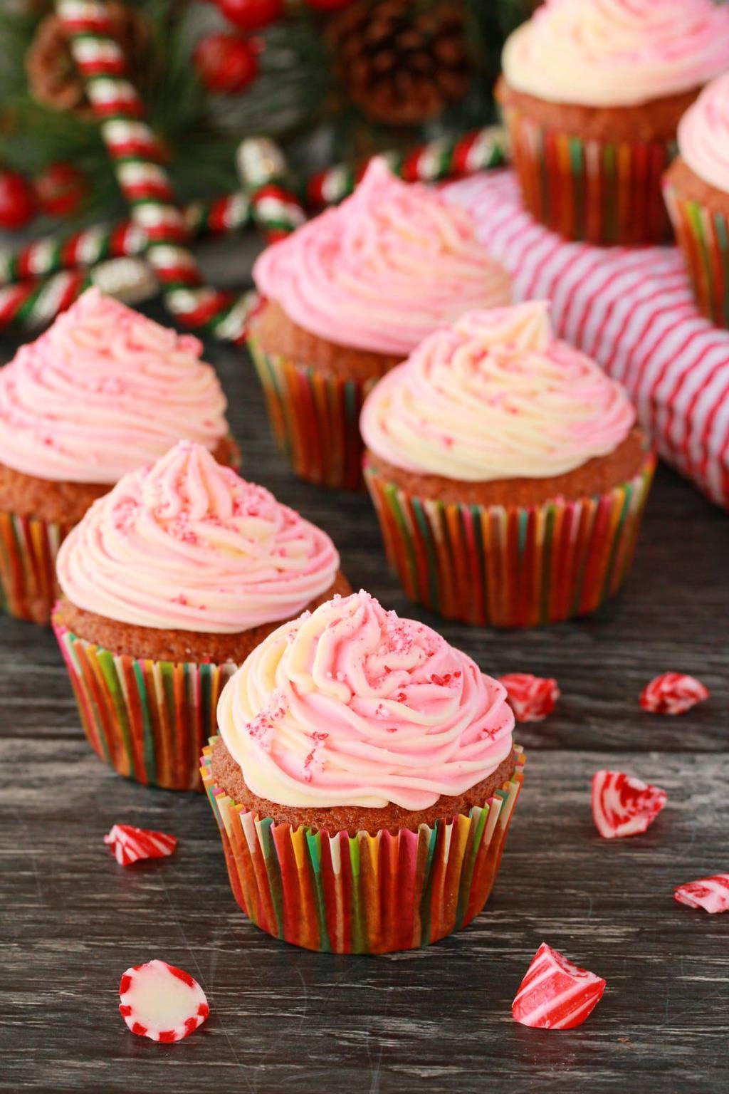 Vegan peppermint cupcakes topped with a pink and white swirled frosting. 