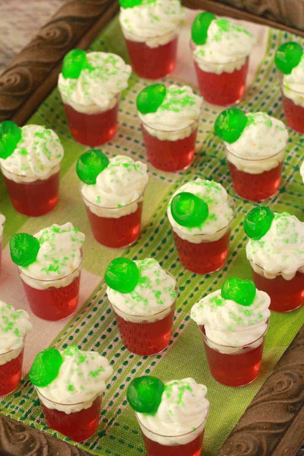 These festive boozy vegan jello shots are perfect for parties! They're colorful, fun and super easy to make! Top with vegan whipped cream! #vegan #lovingitvegan #jelloshots #drinks #glutenfree #dairyfree | lovingitvegan.com