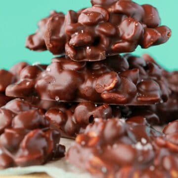 Chocolate peanut clusters in a stack.
