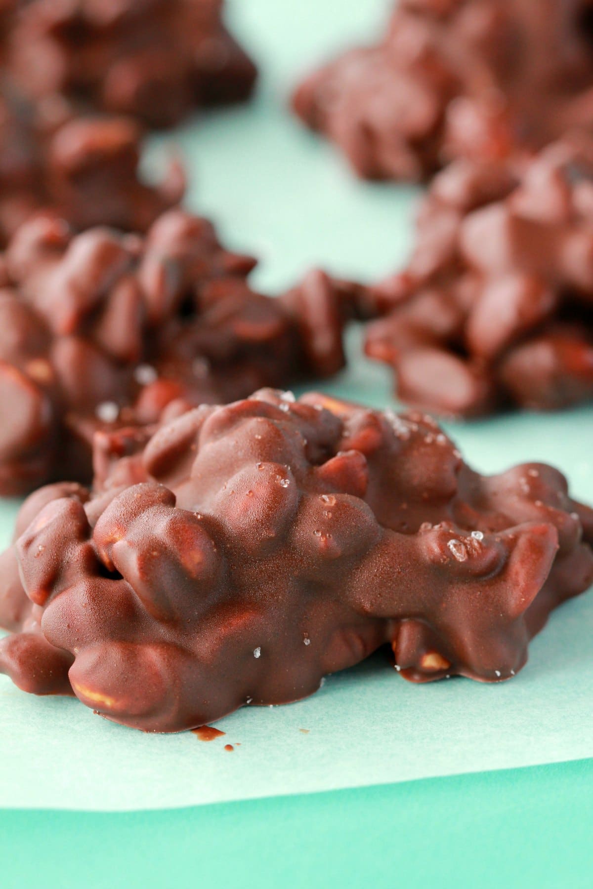 Chocolate Peanut clusters on parchment paper. 