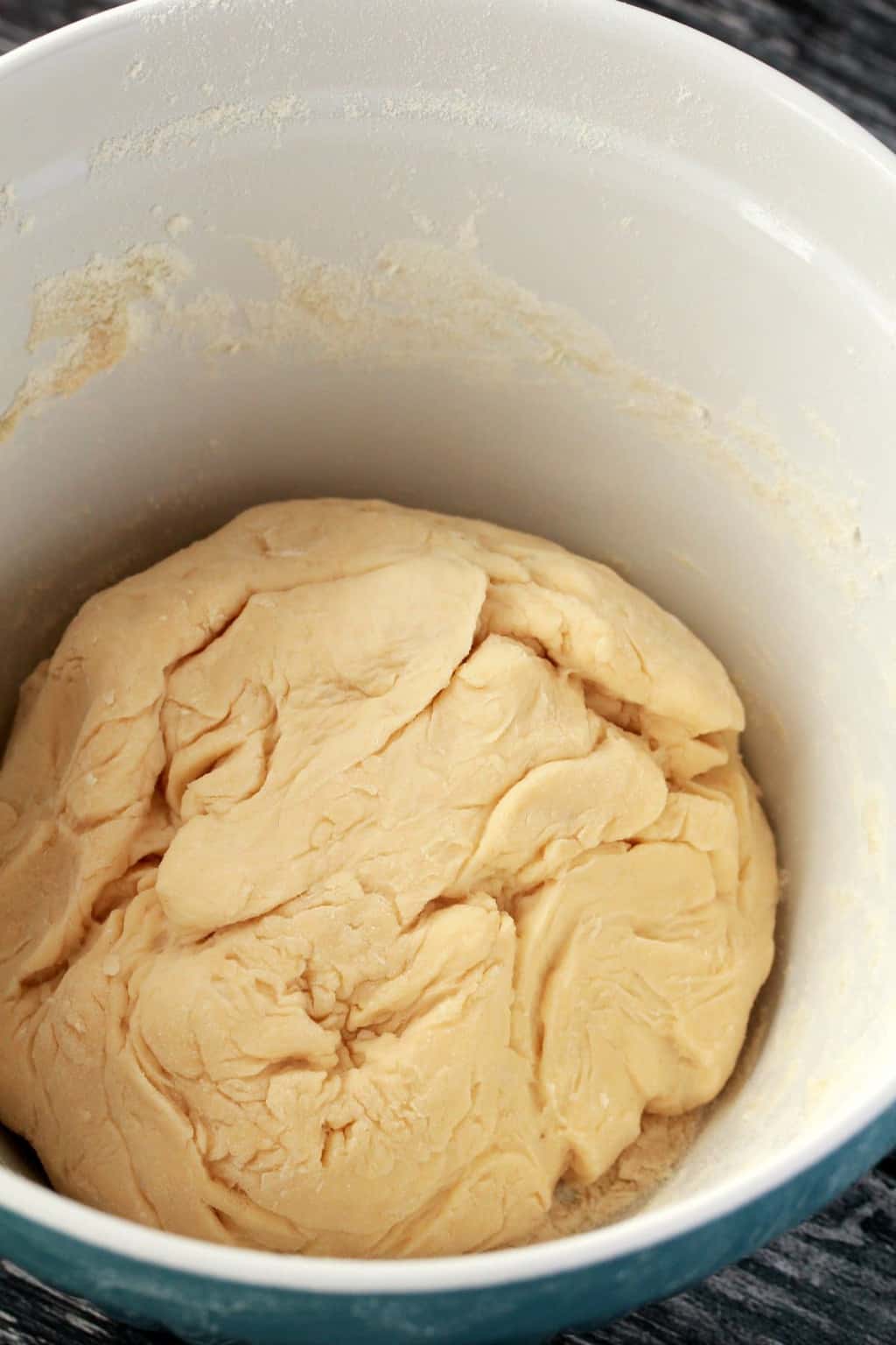 A ball of risen dough in a mixing bowl
