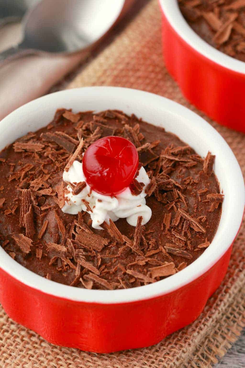 Vegan chocolate mousse in a red and white ramekin. 