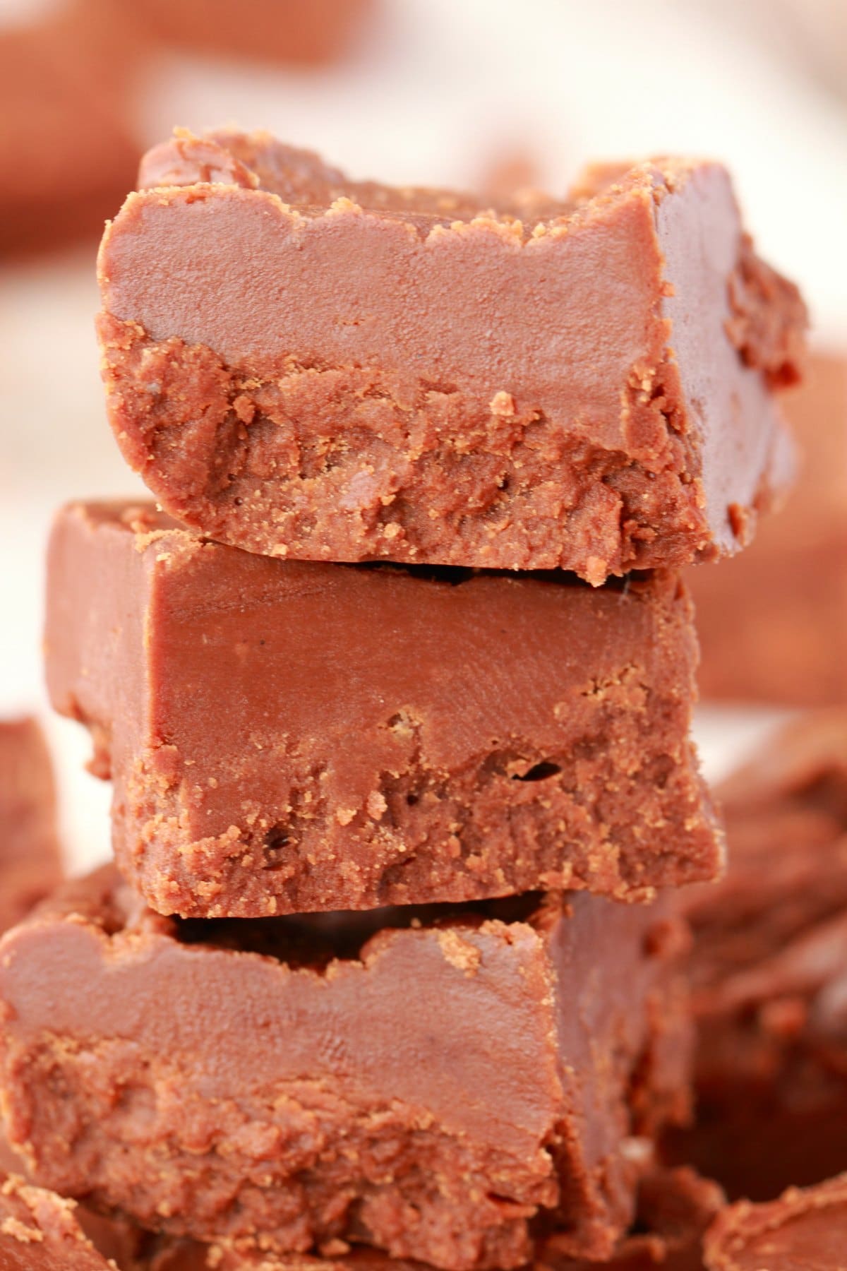 Fudge squares stacked up in a stack of 3. 