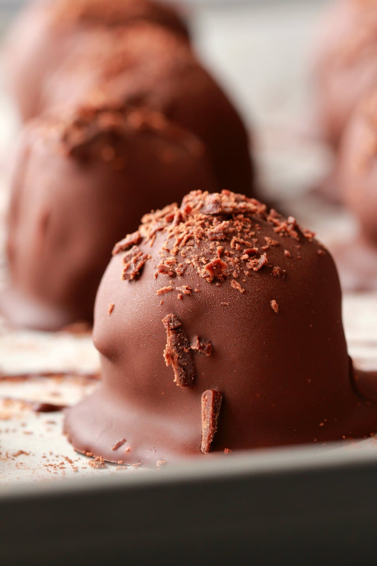 Close up shot of vegan chocolate truffles on a baking tray. 