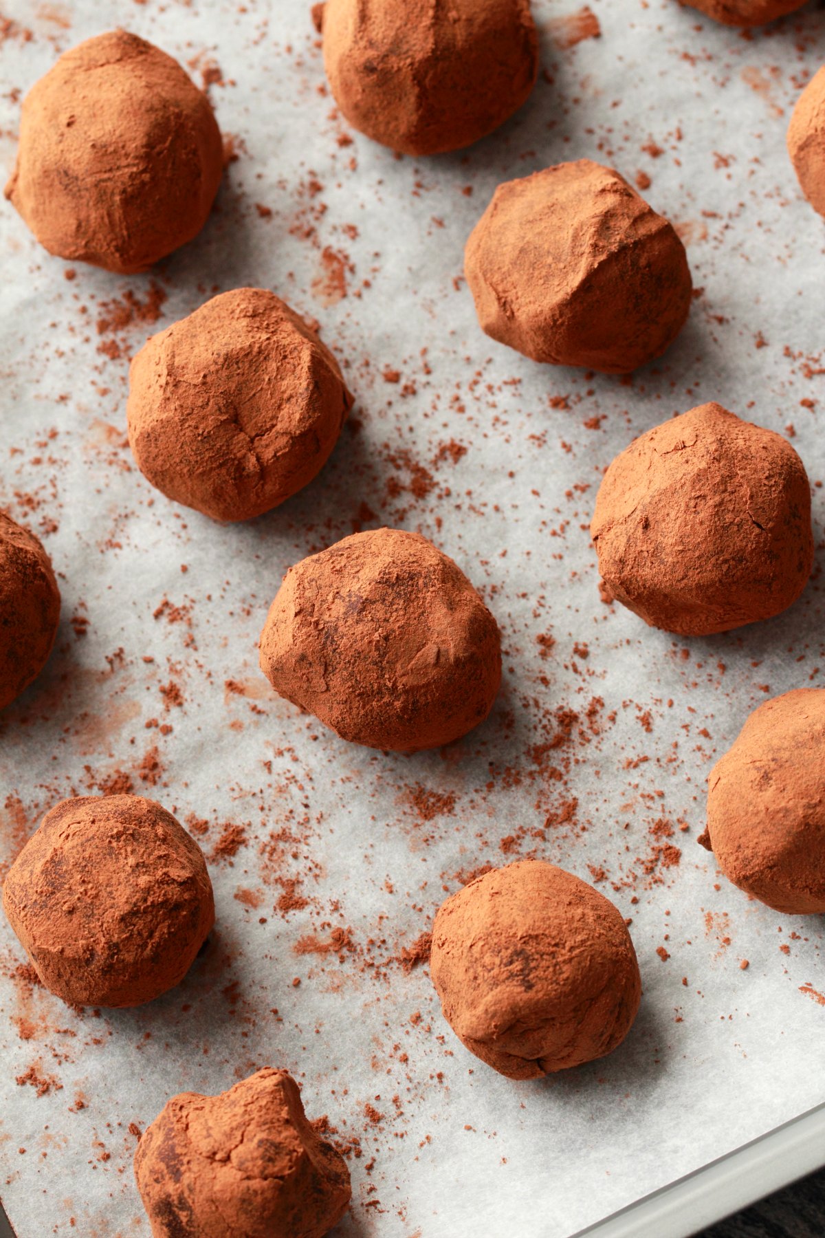 Vegan Chocolate Truffles lined up on parchment paper.