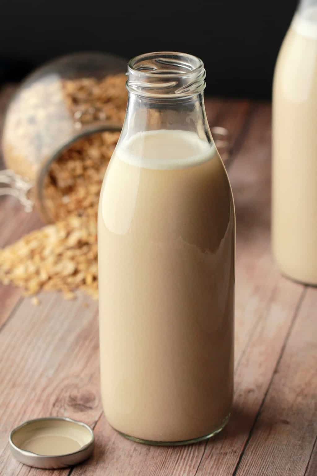 A glass milk bottle filled with homemade oat milk. 